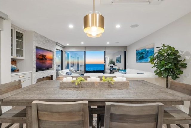 kitchen with kitchen peninsula, white cabinets, a breakfast bar, and decorative light fixtures