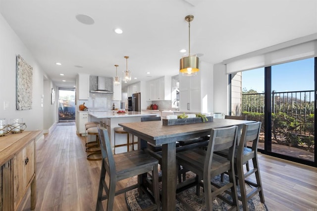 dining space featuring light hardwood / wood-style flooring and a healthy amount of sunlight