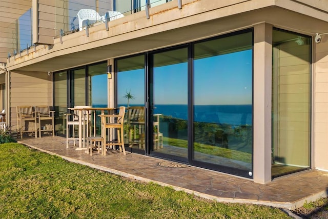 rear view of property with a yard and a patio