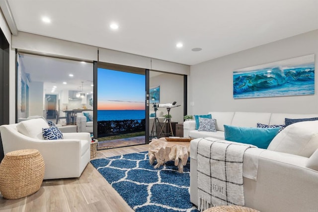 living room featuring a water view and hardwood / wood-style flooring