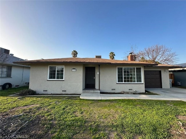 ranch-style house featuring a front lawn and a garage