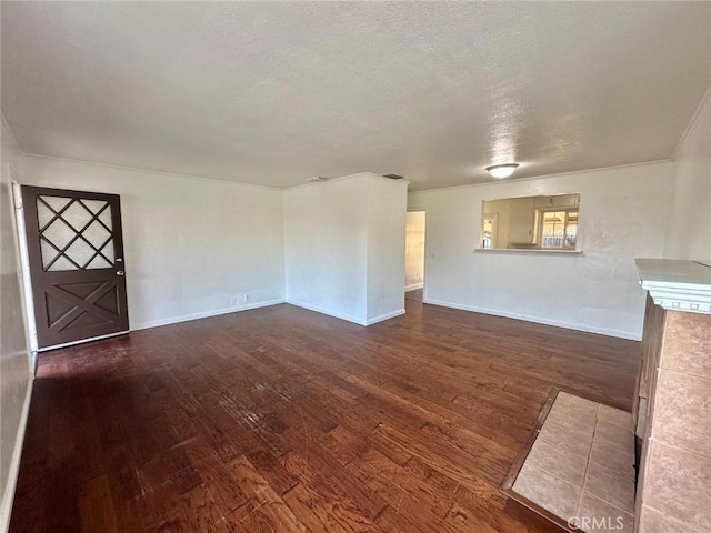 unfurnished living room featuring a textured ceiling and dark hardwood / wood-style floors