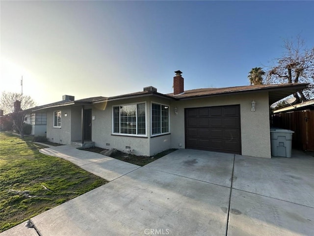 single story home featuring a chimney, stucco siding, an attached garage, crawl space, and driveway