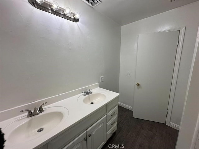 bathroom with hardwood / wood-style floors and vanity