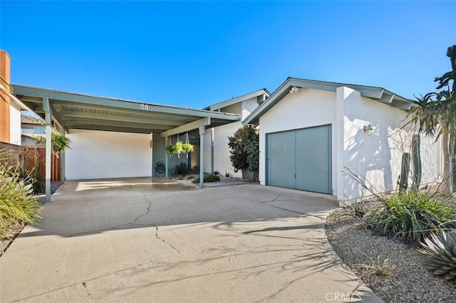 ranch-style house featuring a carport and a garage