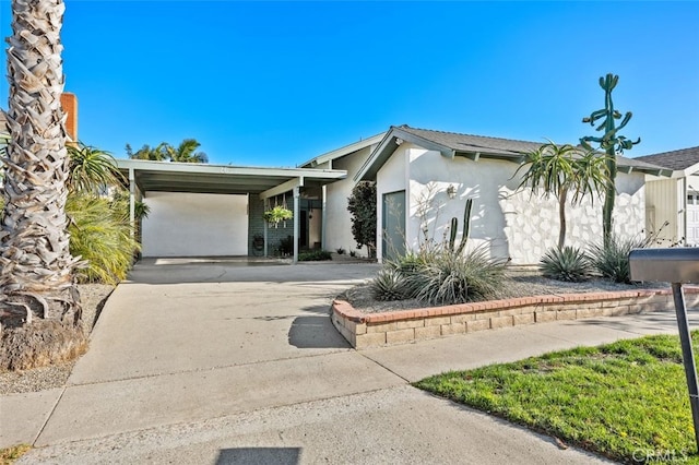 ranch-style home featuring a carport and a garage