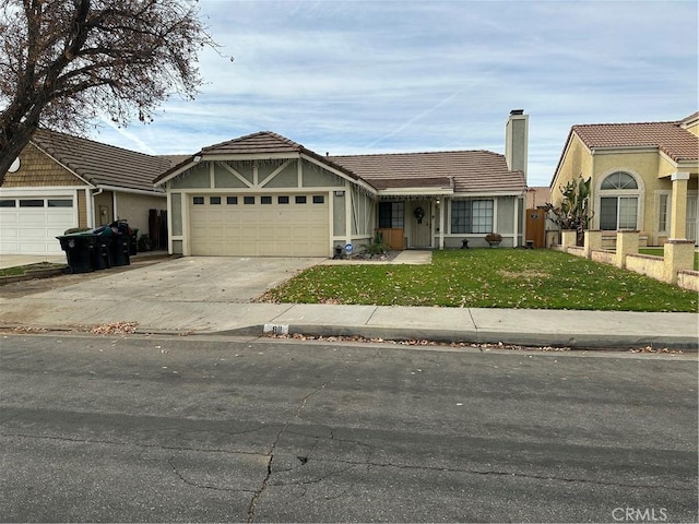 view of front of property featuring a front yard and a garage