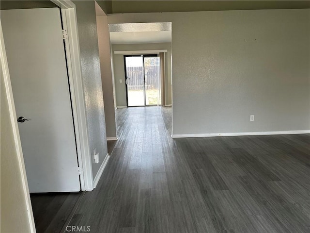 corridor featuring dark hardwood / wood-style flooring