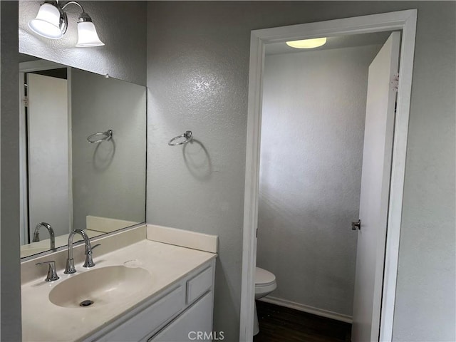 bathroom featuring toilet and vanity