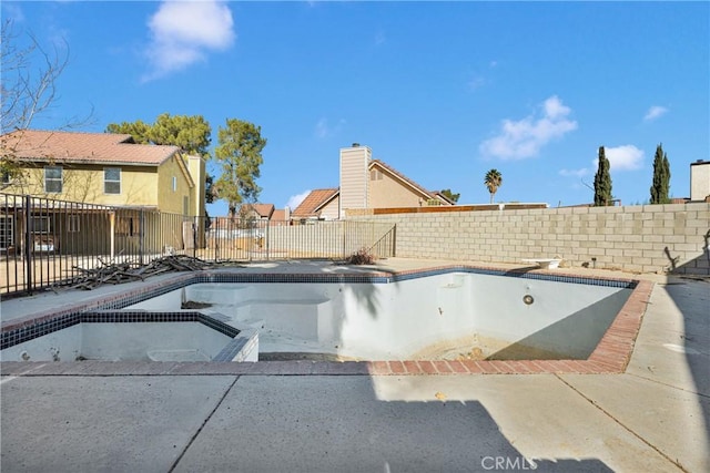 view of pool featuring a diving board, a patio, and an in ground hot tub