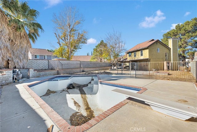 view of swimming pool with a diving board, a hot tub, and a patio