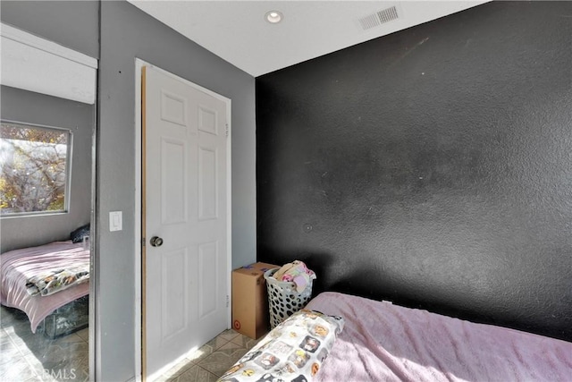 bedroom featuring light tile patterned floors