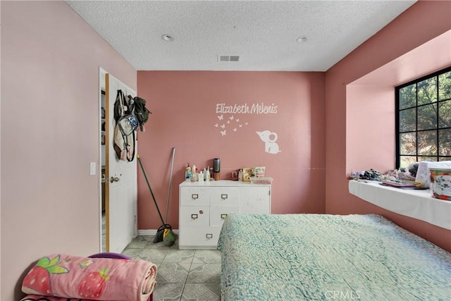 bedroom featuring a textured ceiling