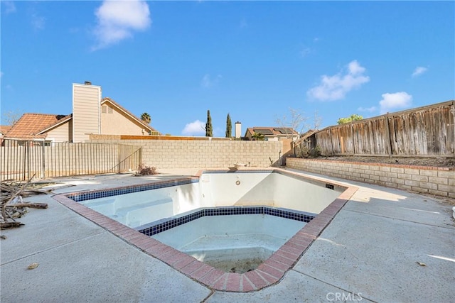 view of pool with an in ground hot tub