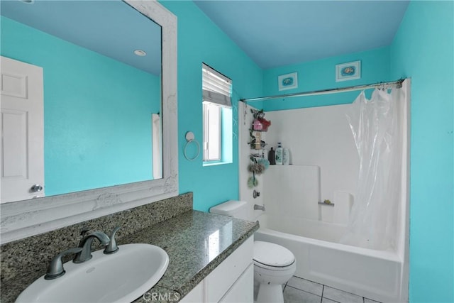 full bathroom featuring toilet, vanity, tile patterned flooring, and shower / bath combo with shower curtain