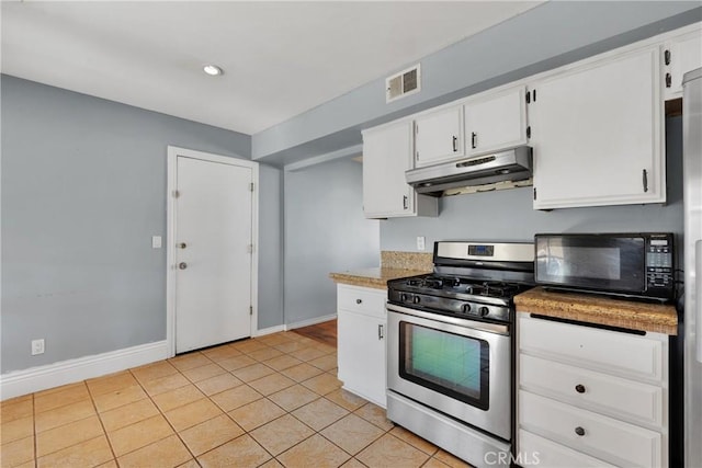 kitchen with light tile patterned floors, white cabinets, and stainless steel range with gas cooktop