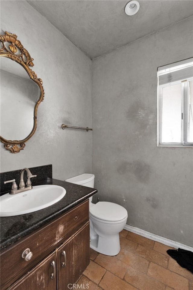 bathroom with toilet and vanity