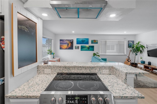 kitchen with stainless steel range with electric cooktop, light stone countertops, and light hardwood / wood-style floors