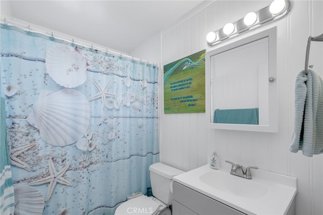 bathroom with vanity, toilet, a shower with shower curtain, and wood walls