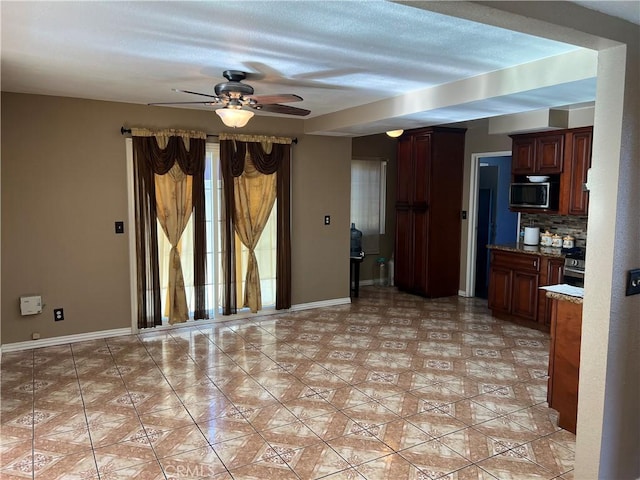 interior space featuring ceiling fan, light tile patterned floors, tasteful backsplash, and light stone counters