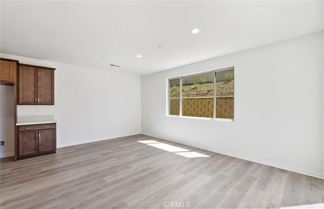 unfurnished living room with light hardwood / wood-style floors