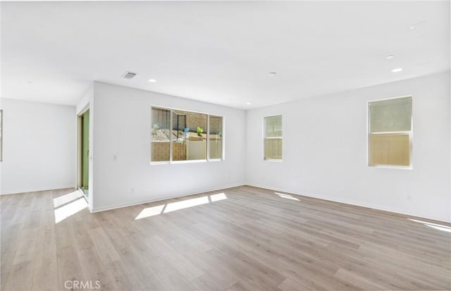 spare room with light hardwood / wood-style floors