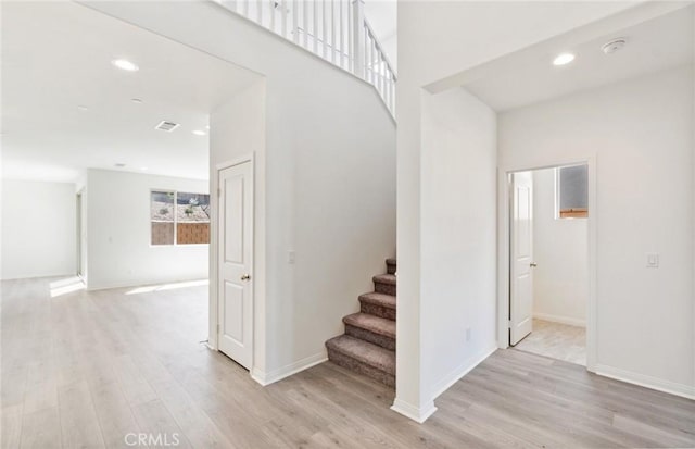 stairs featuring hardwood / wood-style floors