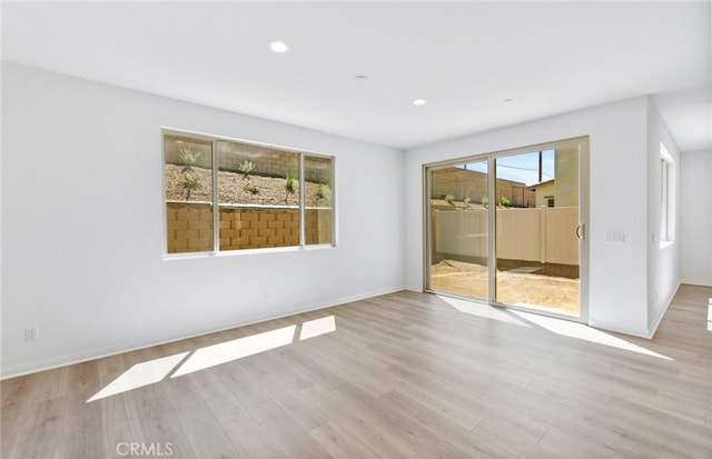 spare room with light hardwood / wood-style flooring