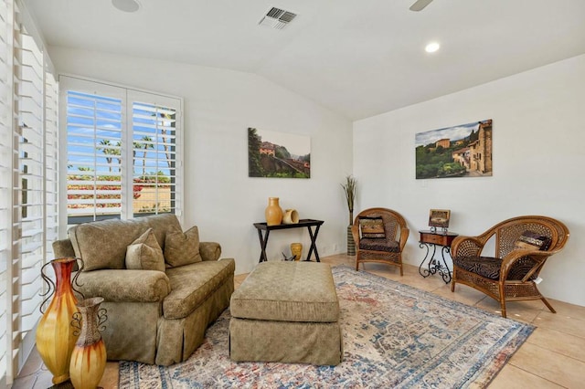 sitting room featuring vaulted ceiling, light tile patterned floors, and ceiling fan