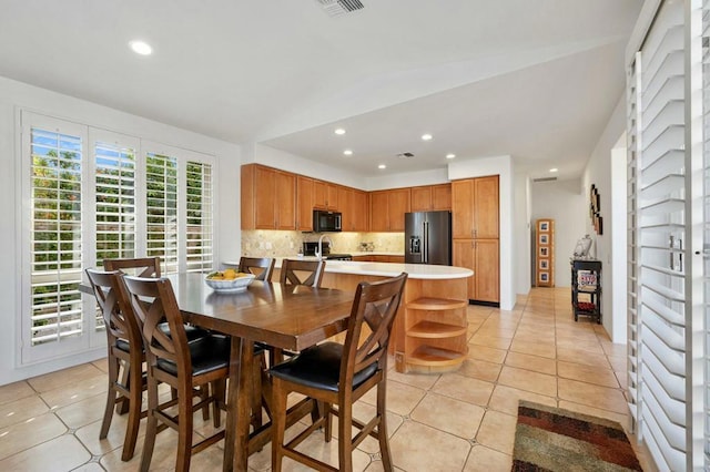 tiled dining area with lofted ceiling