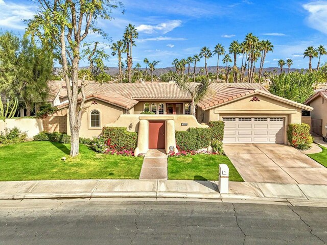 view of front of home featuring a front lawn and a garage