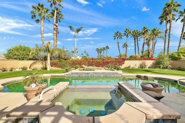 view of pool with an in ground hot tub and a lawn