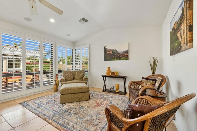 sitting room featuring lofted ceiling, ceiling fan, and light tile patterned flooring