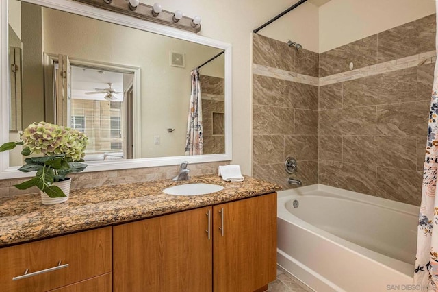 bathroom featuring ceiling fan, vanity, and shower / bathtub combination with curtain