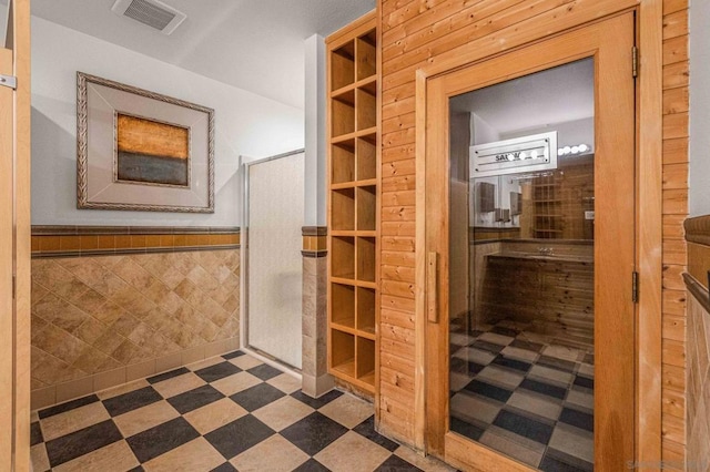 bathroom with tile walls