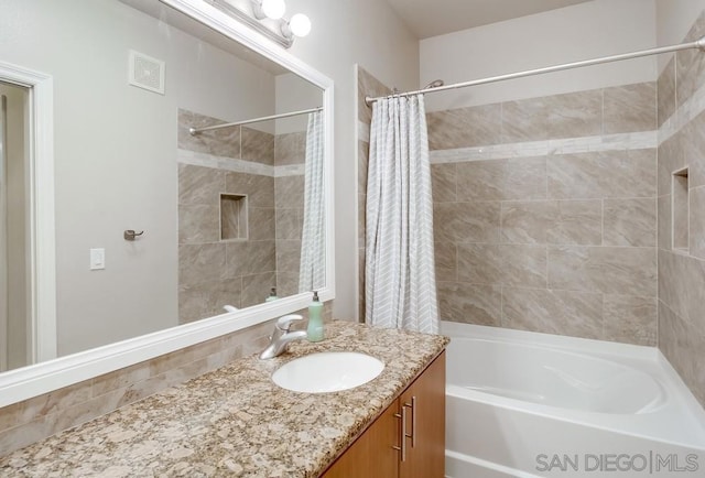 bathroom with vanity and shower / tub combo with curtain