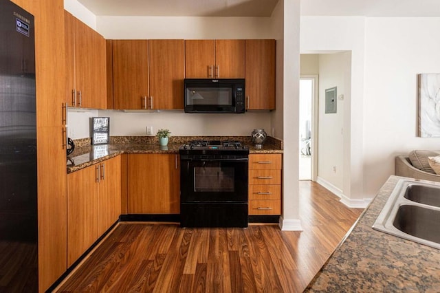 kitchen featuring sink, dark hardwood / wood-style floors, and black appliances