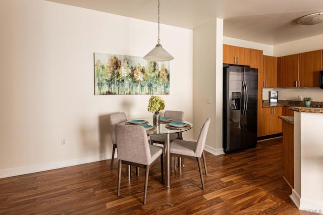 dining area with dark hardwood / wood-style flooring