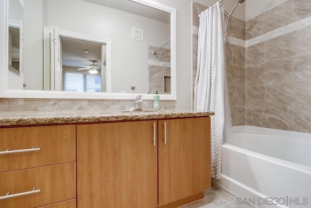 bathroom featuring ceiling fan, vanity, and shower / bath combination with curtain