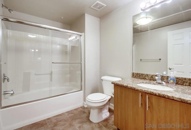 full bathroom with toilet, enclosed tub / shower combo, and vanity