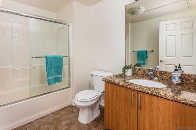 full bathroom featuring toilet, enclosed tub / shower combo, and vanity