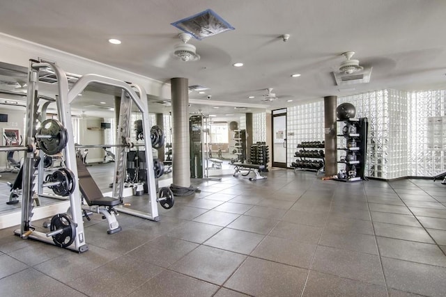 exercise room with ceiling fan and ornamental molding