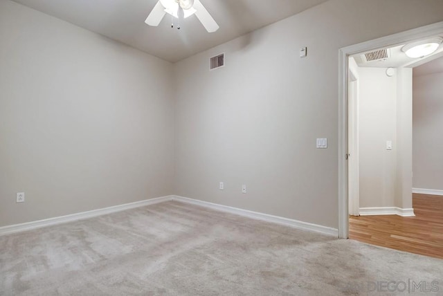 carpeted empty room with ceiling fan