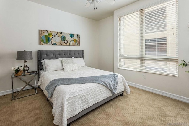 bedroom with ceiling fan, multiple windows, and carpet