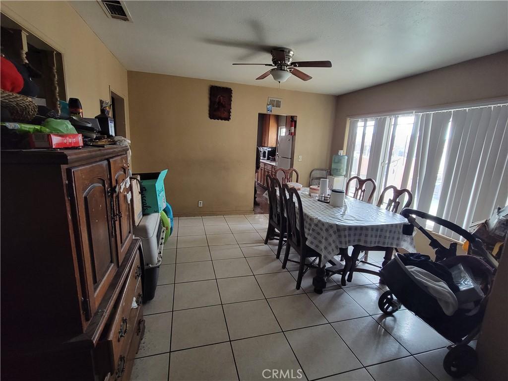 tiled dining area featuring ceiling fan