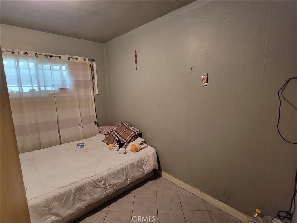 bedroom featuring light tile patterned floors