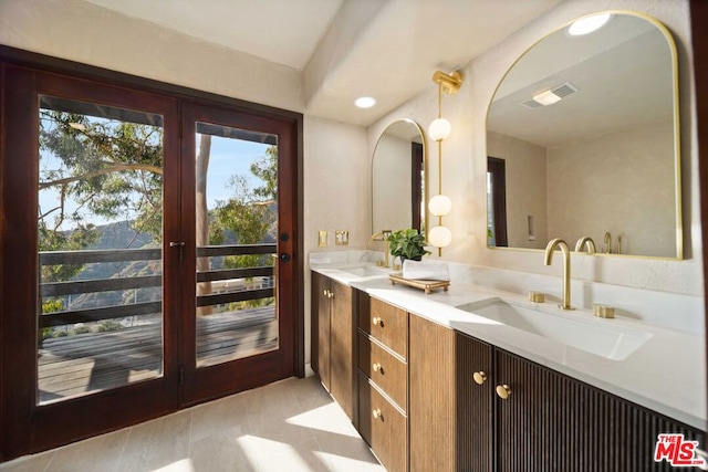 bathroom with plenty of natural light, tile patterned floors, and vanity