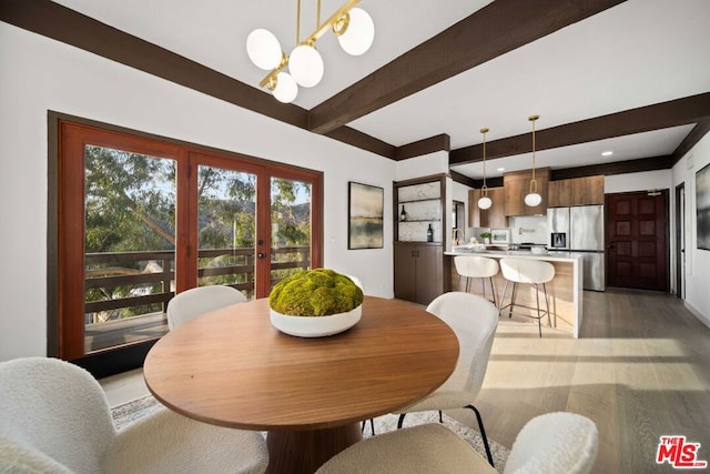 dining area featuring french doors, beamed ceiling, and hardwood / wood-style floors