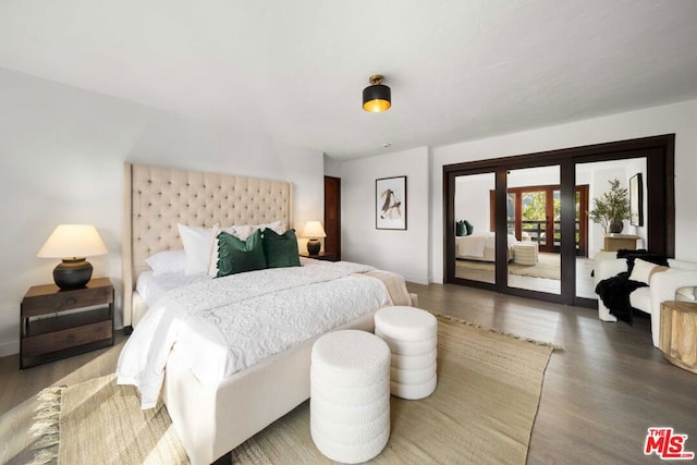 bedroom featuring access to exterior and dark hardwood / wood-style flooring