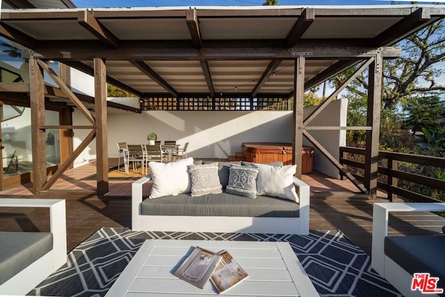 view of patio / terrace with an outdoor living space, a wooden deck, and a hot tub